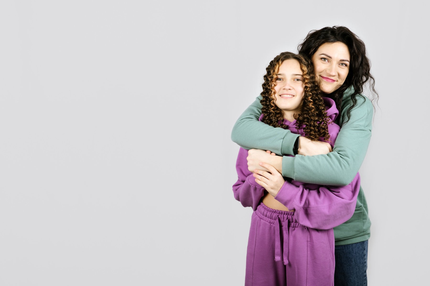 Portrait of happy mom and teen daughter spend time together.